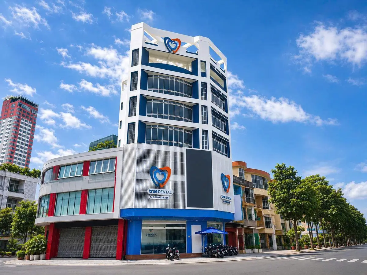Corner clinic building with blue and white facade and True Dental logo under a blue sky
