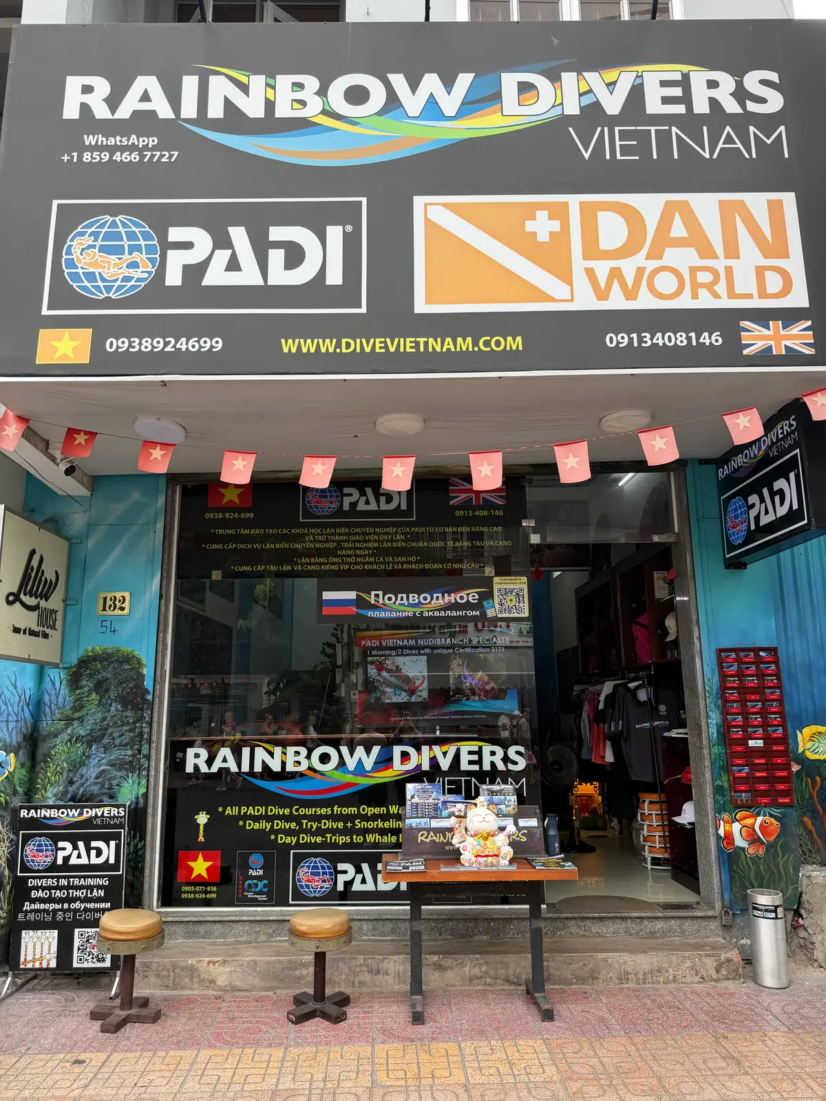 Dive shop front with PADI signs, a window display and strings of small flags