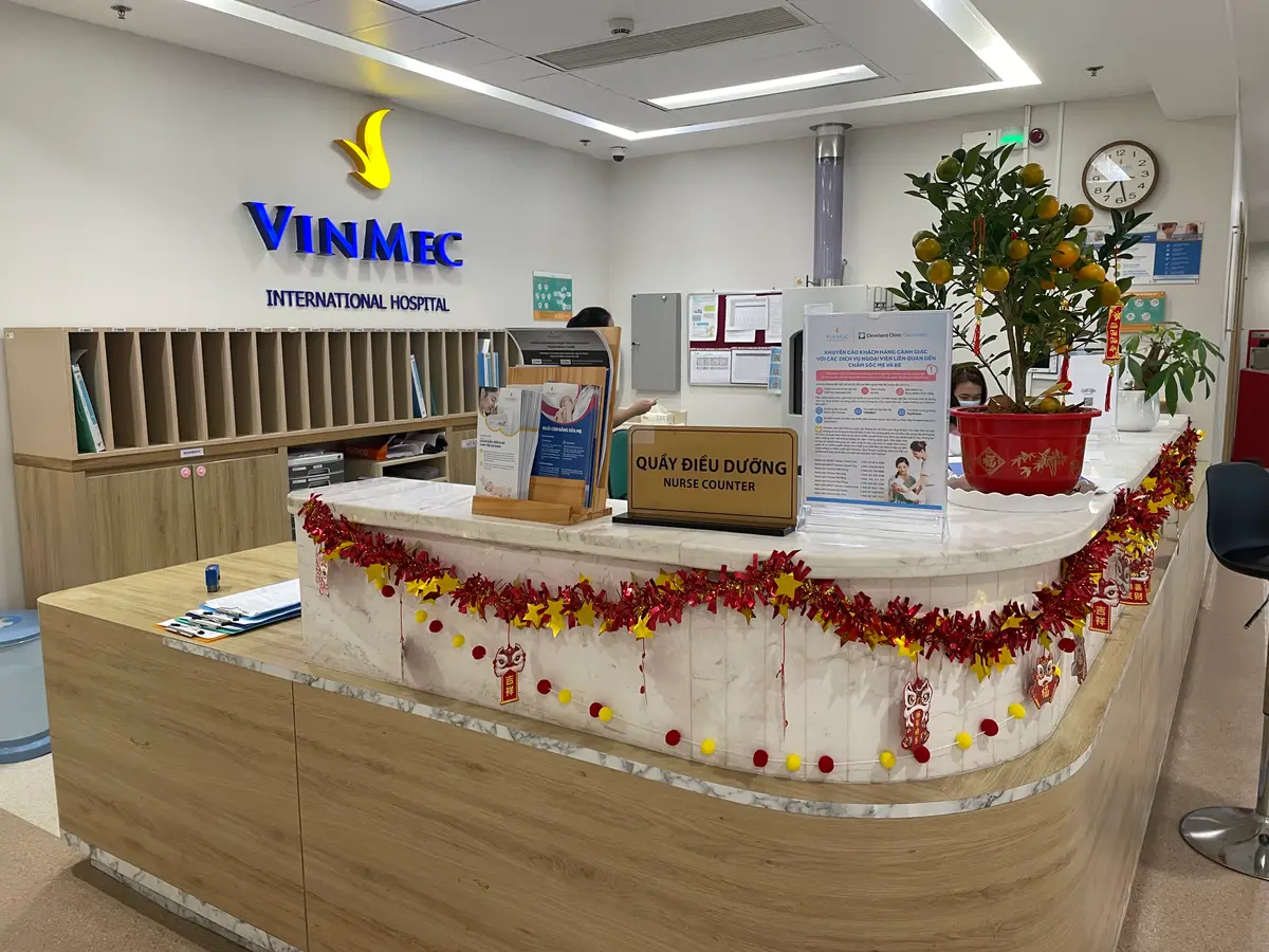 Reception desk with the hospital logo on the wall and a decorated counter