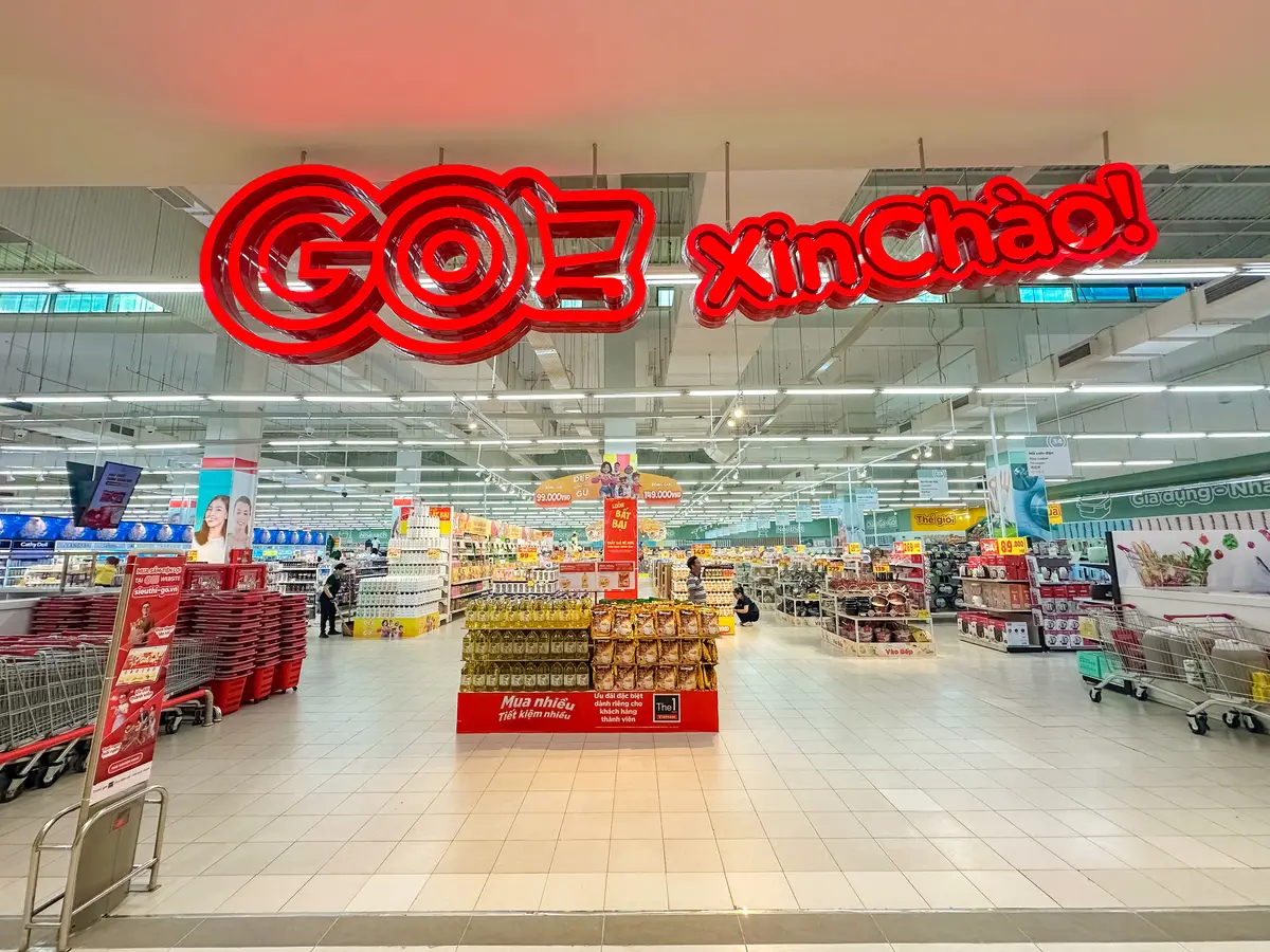 Hypermarket entrance hall with a red Xin Chao sign above the aisles