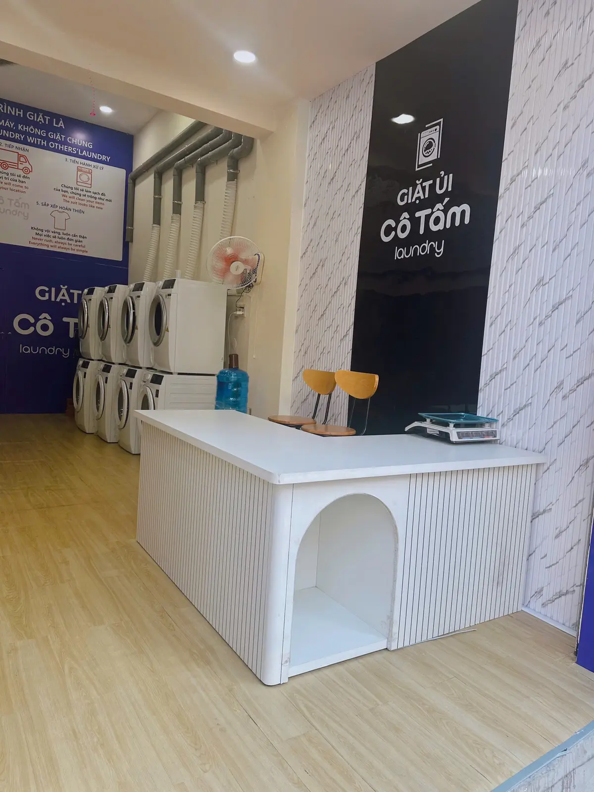 Laundry counter with a scale and washing machines along the wall