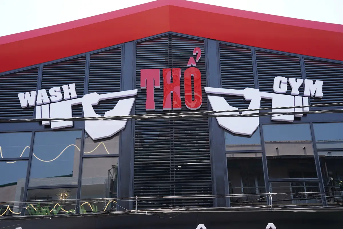 Red and black Tho Gym building front with a large sign