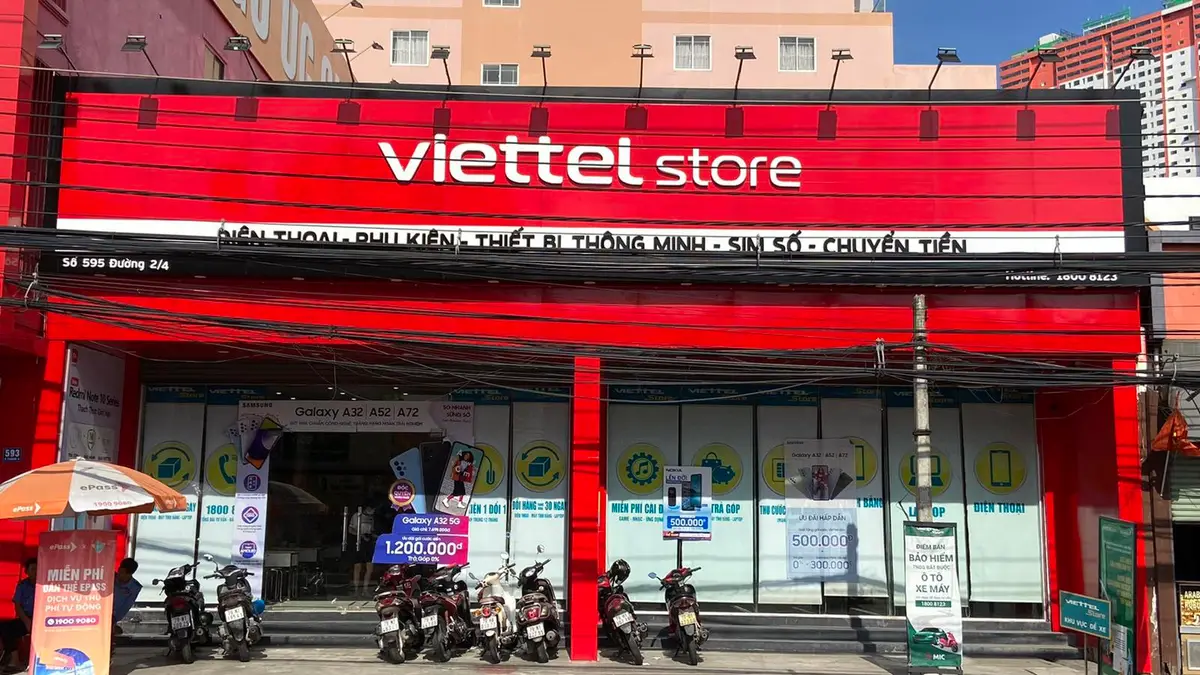 Red shopfront of a Viettel Store in Nha Trang with the store name over the entrance and signs for phones, SIM cards and money transfer
