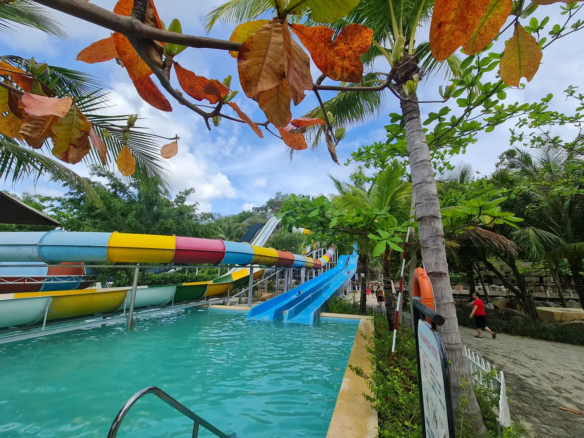 Colourful water slides beside a turquoise pool at I-Resort
