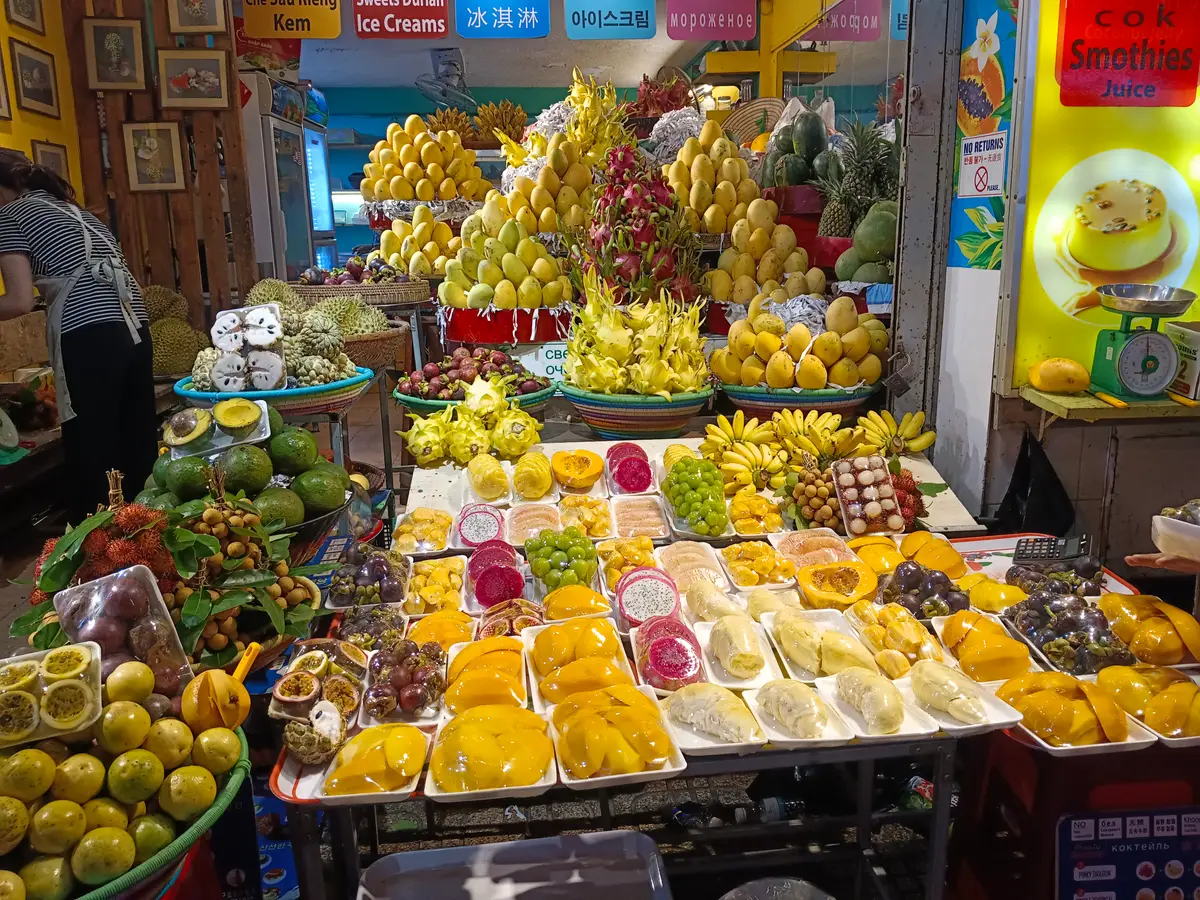 Fruit stall piled with mangoes, dragon fruit and other fruit
