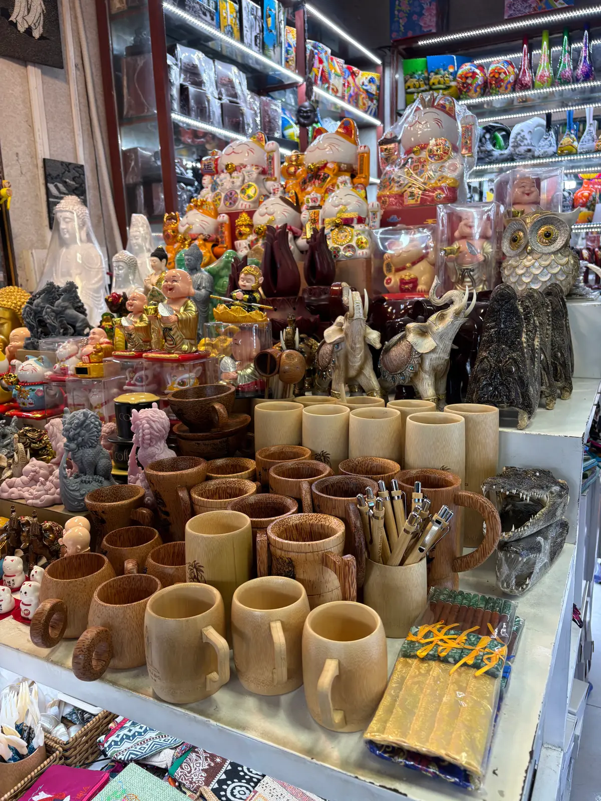 Bamboo cups, carved figures and souvenirs on a market table