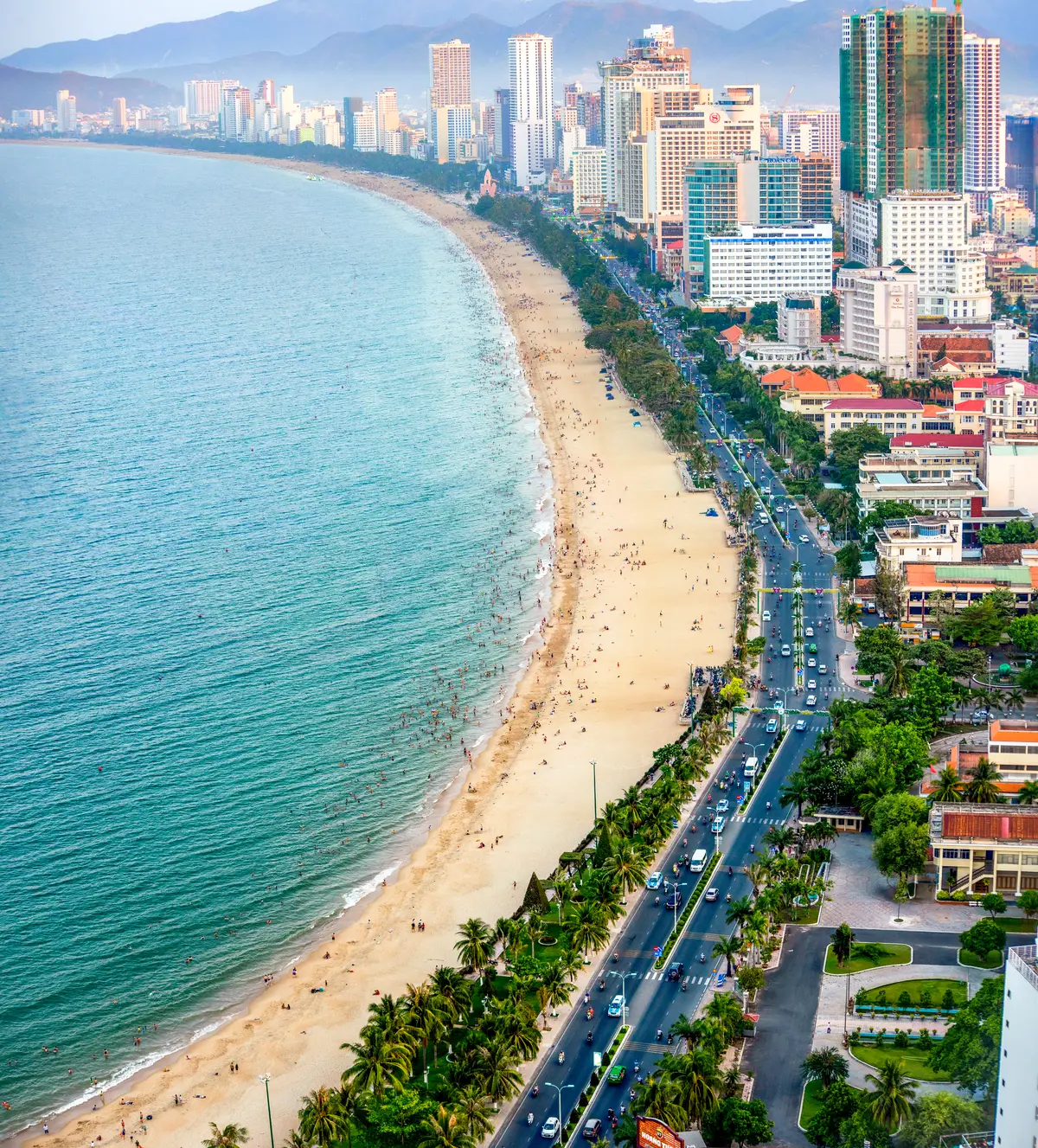 Aerial view of Nha Trang beach and the coastal road running along the open bay, with hotels on the landward side