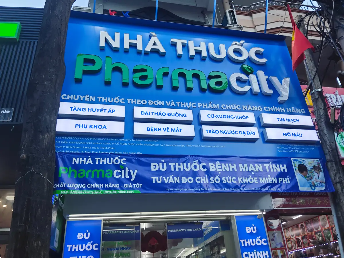 Blue Pharmacity signboard listing the conditions the pharmacy advises on