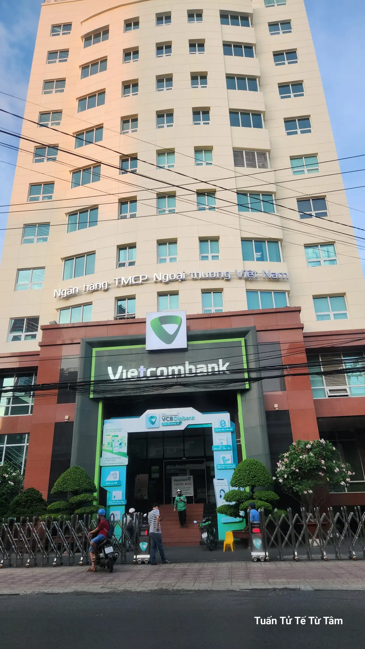 Front of the multi-storey Vietcombank building with the bank logo above the entrance and a tall office facade.