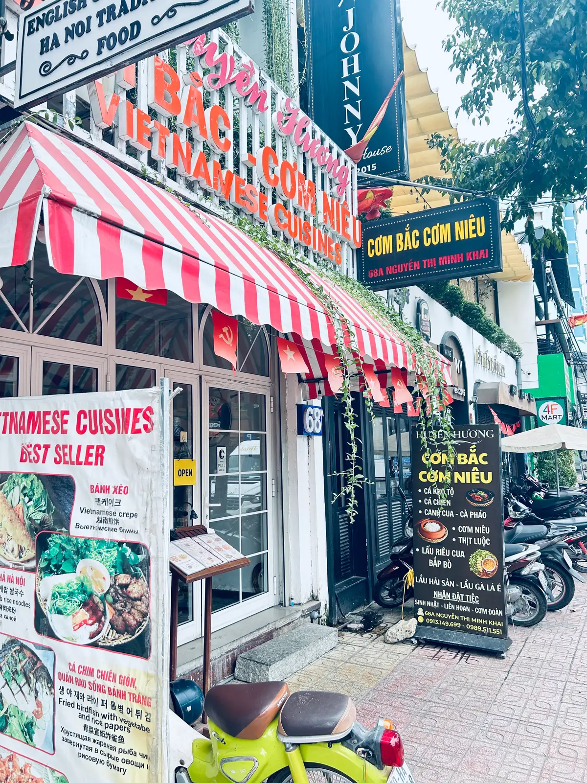 Restaurant front with a red and white striped awning and a menu board